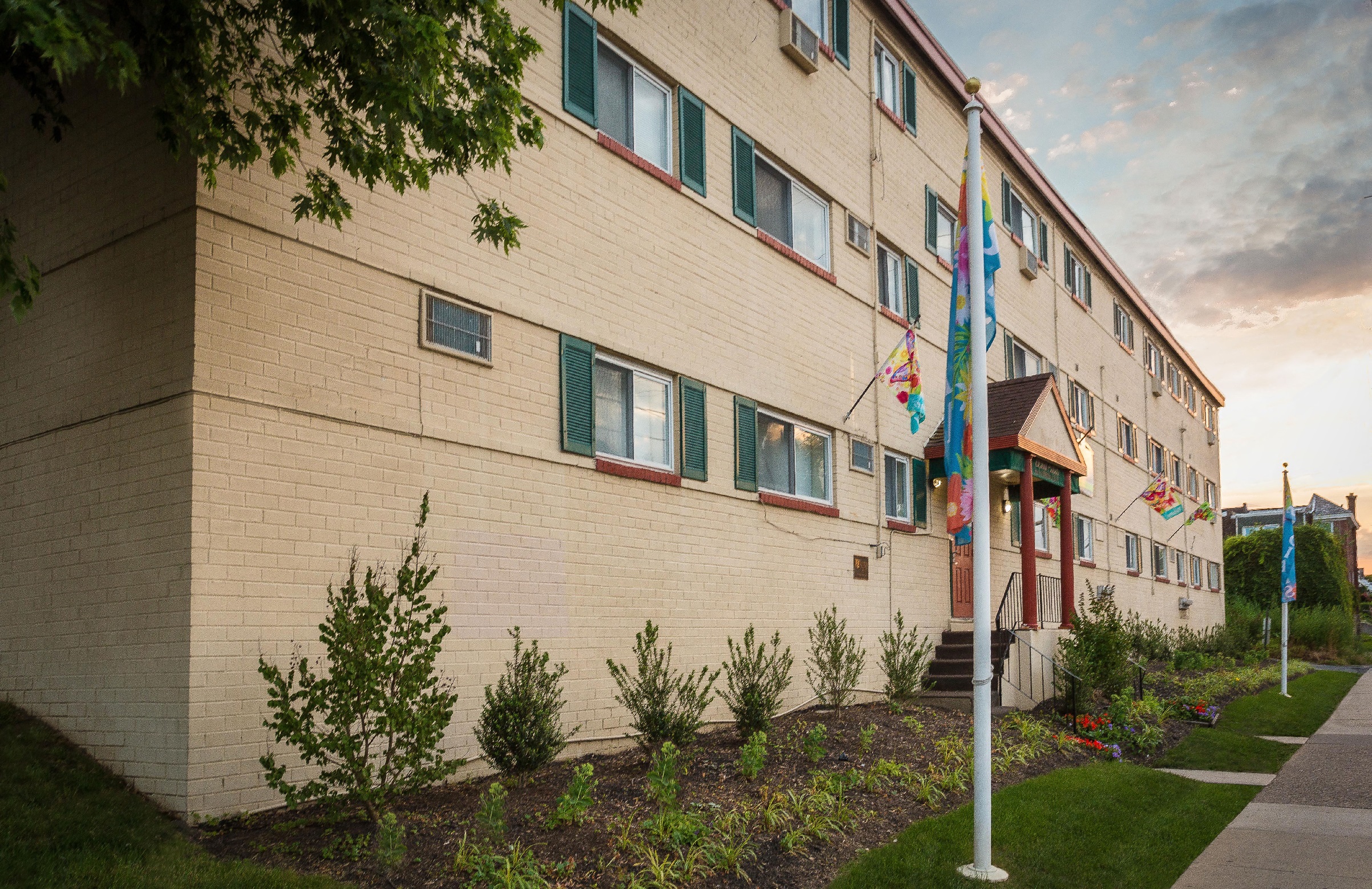 A building with a flag hanging from the front.